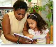 Adult and child reading in library